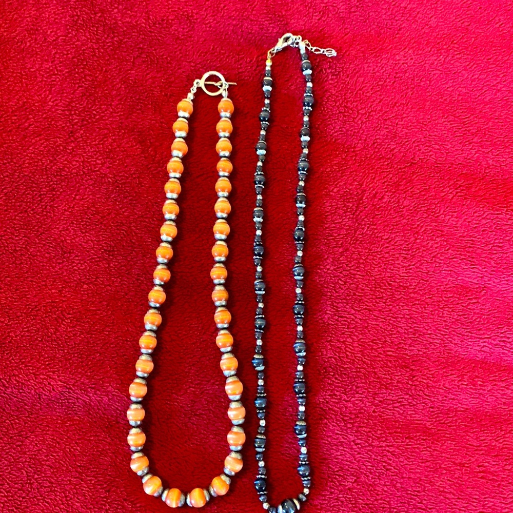 Two necklaces - one black and silver, the other copper and silver.